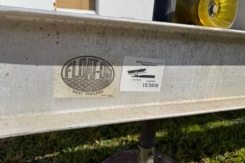 Slide: The Image of Trailer with "Float-On" logo and expired permit, for 2006 Grady-White Sailfish 282 boat. - 42