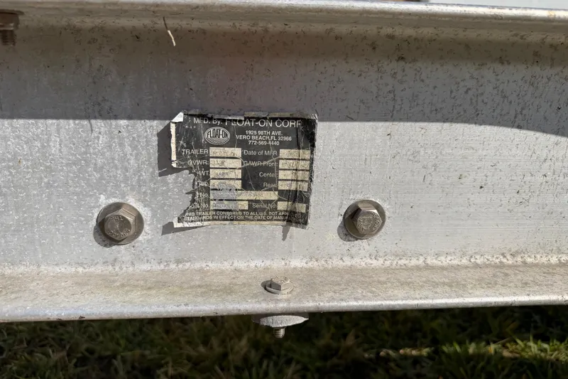 Slide: The Image of 2006 Grady-White Sailfish 282 trailer label with bolts on metal frame. - 43