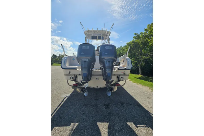Slide: The Image of 2006 Grady-White Sailfish 282 boat on trailer, parked outdoors under clear blue sky. - 5