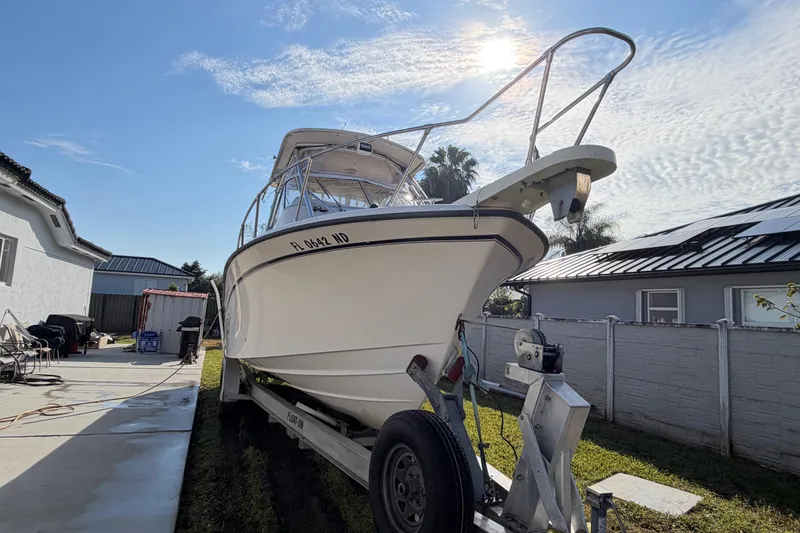 Slide: The Image of 2006 Grady-White Sailfish 282 boat on trailer in sunny backyard setting. - 54