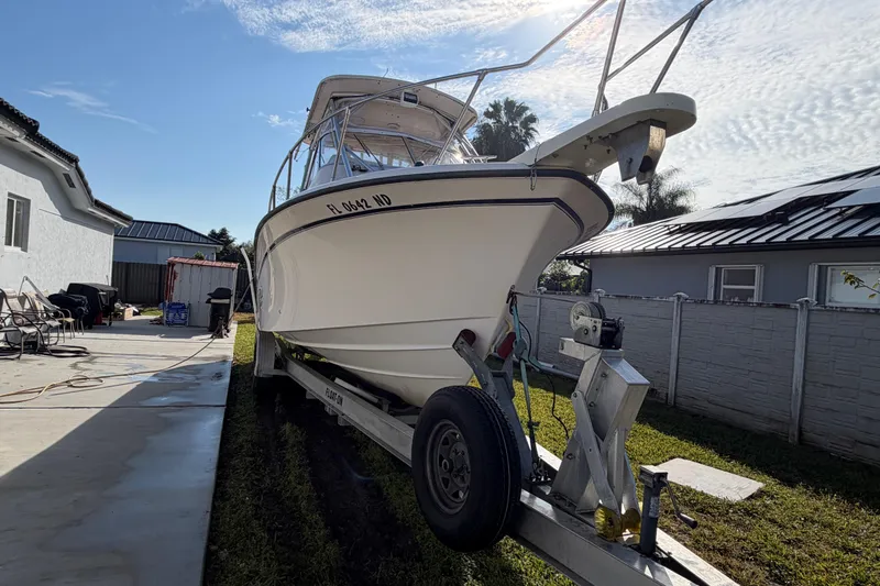 Slide: The Image of 2006 Grady-White Sailfish 282 boat on trailer in residential driveway. - 55