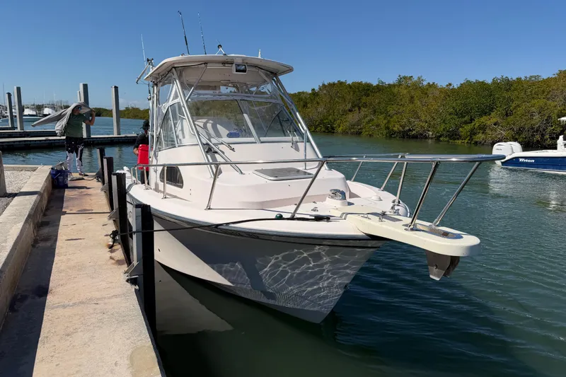 Slide: The Image of 2006 Grady-White Sailfish 282 docked at marina, clear sky, calm water. - 58