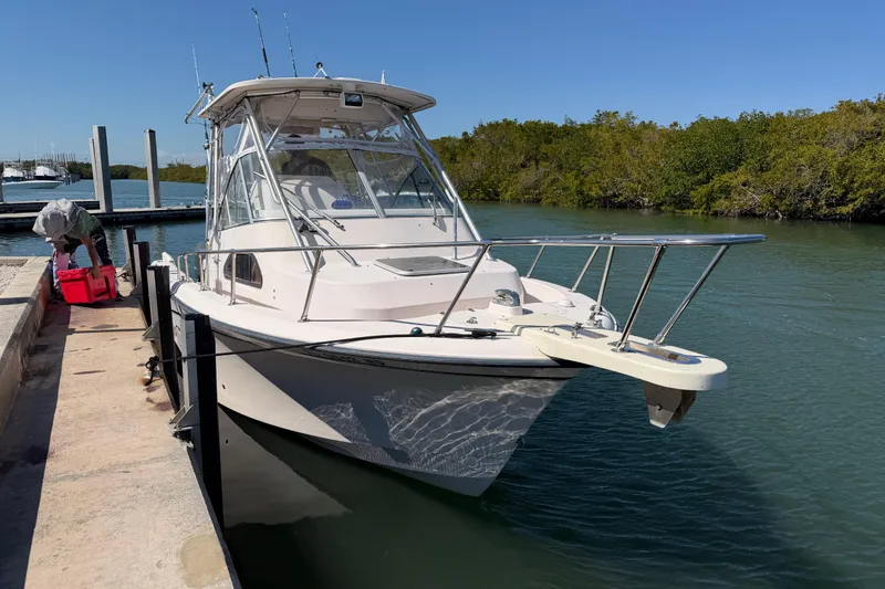 Slide: The Image of 2006 Grady-White Sailfish 282 docked by a serene waterway. - 59