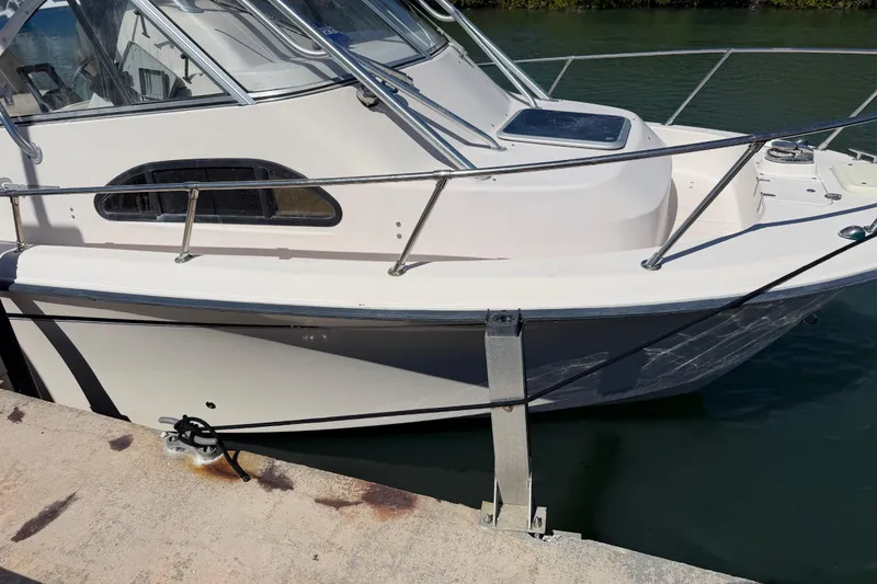 Slide: The Image of 2006 Grady-White Sailfish 282 boat docked at marina, side view. - 61