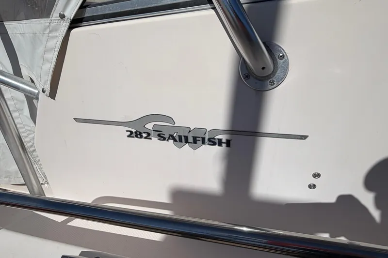 Slide: The Image of 2006 Grady-White Sailfish 282 boat logo with metal railing in sunlight. - 63