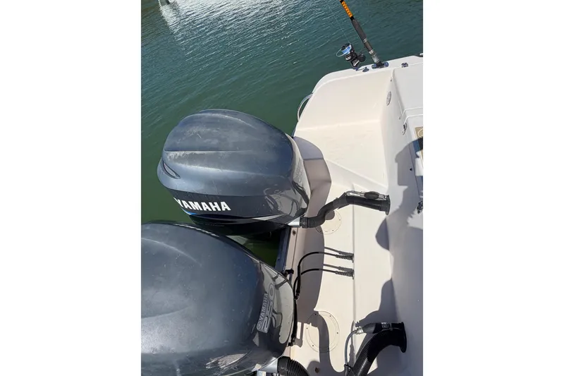 Slide: The Image of 2006 Grady-White Sailfish 282 with Yamaha outboard motors, docked on calm water. - 65