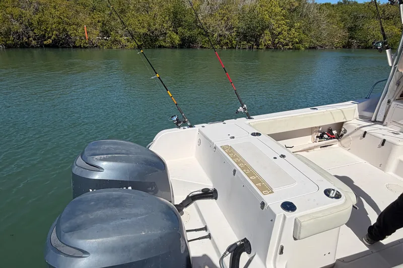 Slide: The Image of 2006 Grady-White Sailfish 282 boat with fishing rods and dual engines on calm water. - 67