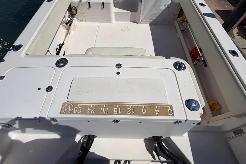 Slide: The Image of 2006 Grady-White Sailfish 282 boat interior with fishing equipment and measuring board. - 73