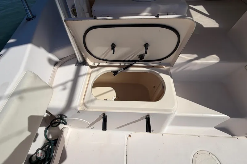 Slide: The Image of 2006 Grady-White Sailfish 282 boat storage compartment with open hatch. - 80