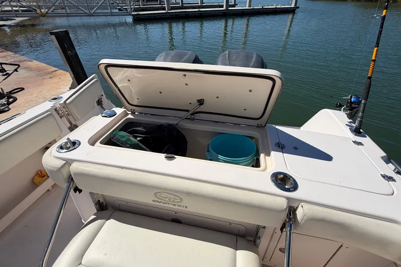Slide: The Image of 2006 Grady-White Sailfish 282 boat with open storage compartment at dock. - 82