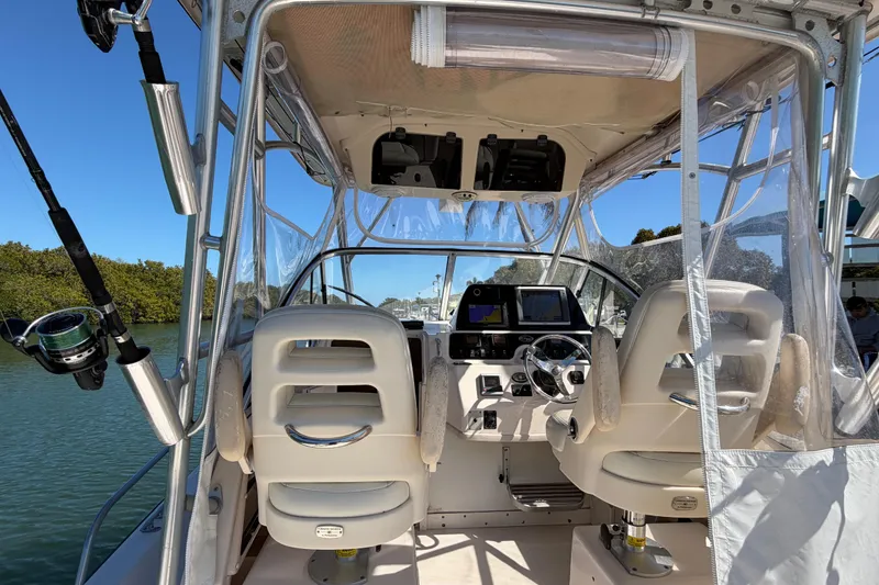 Slide: The Image of 2006 Grady-White Sailfish 282 boat interior with helm, seats, and fishing rod. - 86