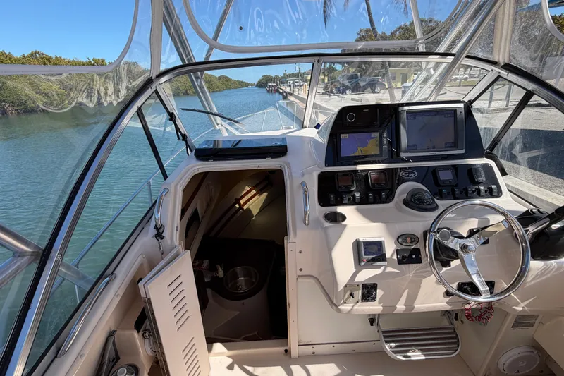Slide: The Image of 2006 Grady-White Sailfish 282 boat cockpit with navigation equipment and steering wheel. - 89