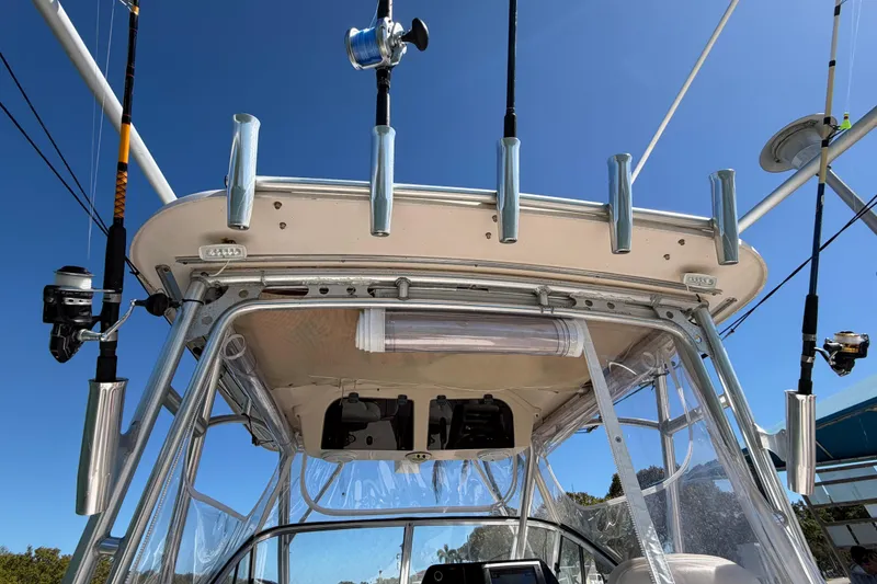 Slide: The Image of 2006 Grady-White Sailfish 282 boat with fishing rods and equipment under clear blue sky. - 91