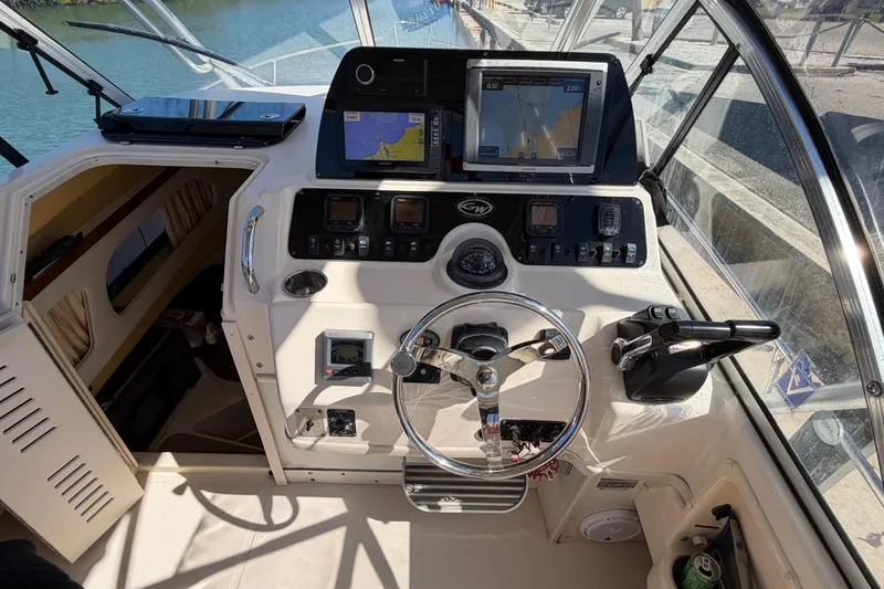 Slide: The Image of Helm of 2006 Grady-White Sailfish 282 with navigation equipment and steering wheel. - 92