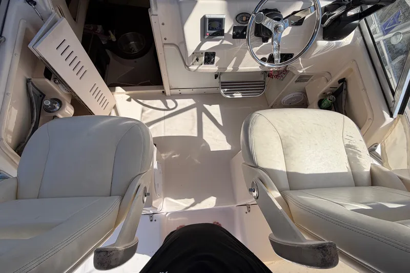 Slide: The Image of Interior of a 2006 Grady-White Sailfish 282 boat with steering wheel and seats. - 93