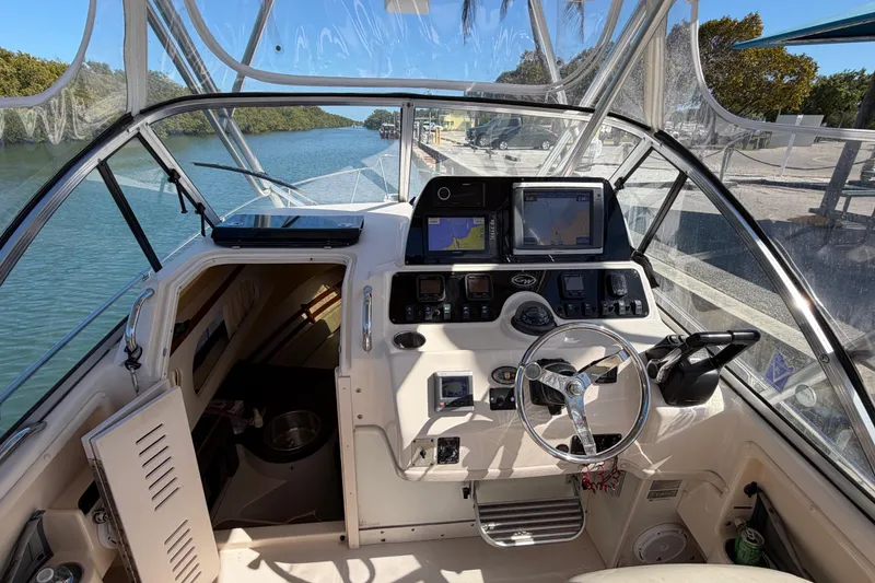 Slide: The Image of 2006 Grady-White Sailfish 282 boat cockpit with navigation equipment and steering wheel. - 94