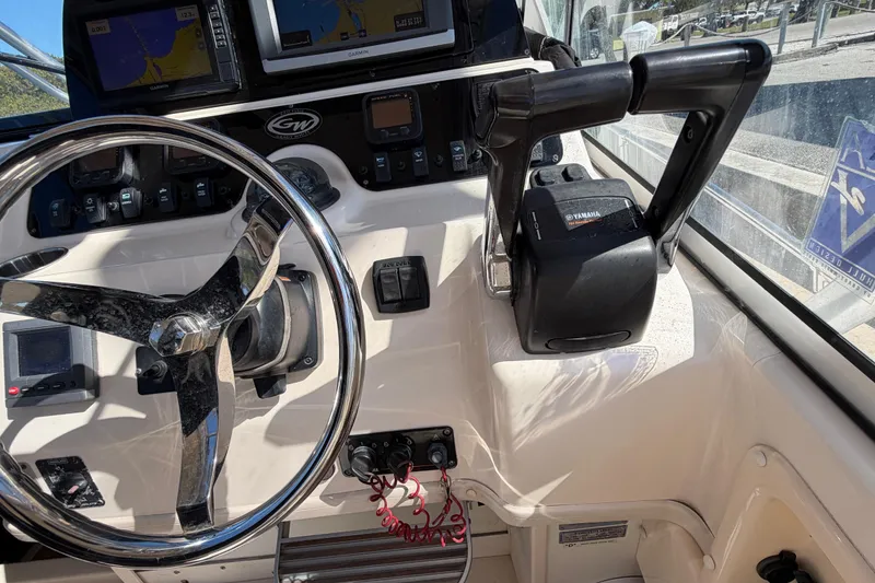 Slide: The Image of 2006 Grady-White Sailfish 282 helm with steering wheel, Yamaha controls, and navigation displays. - 95