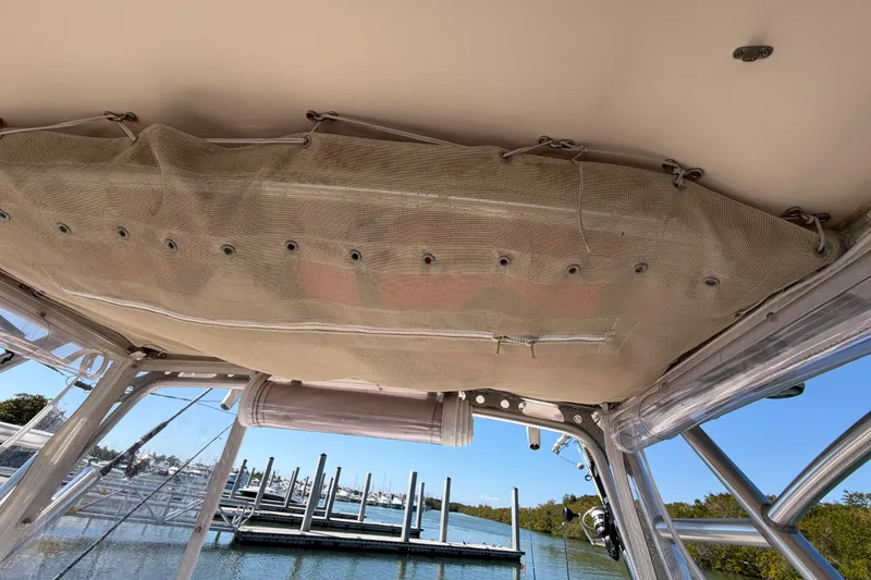 Slide: The Image of 2006 Grady-White Sailfish 282 boat interior with netting and dock view. - 98