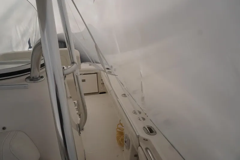 Slide: The Image of 2018 Regulator 23 boat interior with white seating and metal railings. - 10