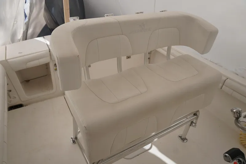 Slide: The Image of 2018 Regulator 23 boat with white cushioned seating and stainless steel frame. - 13