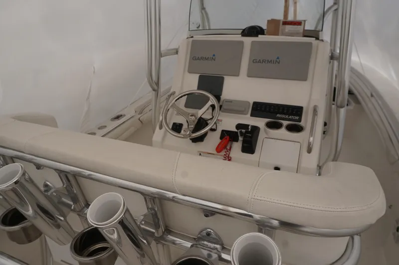 Slide: The Image of 2018 Regulator 23 boat console with Garmin electronics and rod holders. - 2
