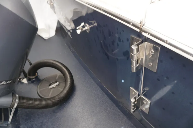 Slide: The Image of 2018 Regulator 23 boat interior with engine and stainless steel hinges. - 3