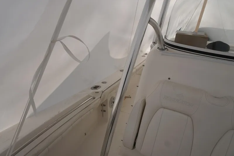 Slide: The Image of 2018 Regulator 23 boat interior with white seating and console. - 9