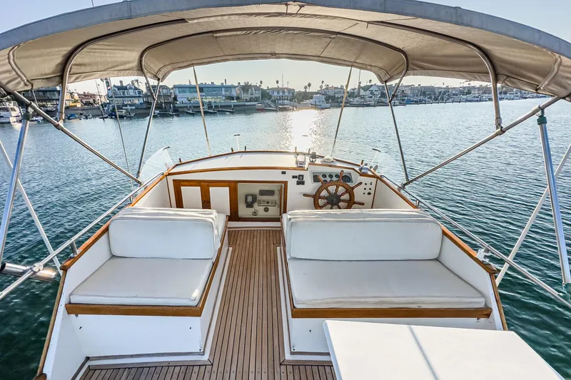 Slide: The Image of 1984 Grand Banks 42 Classic yacht interior with helm, seating, and waterfront view. - 10