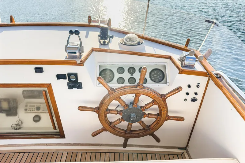Slide: The Image of Helm of 1984 Grand Banks 42 Classic yacht with wooden wheel and gauges. - 12