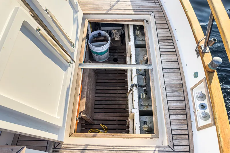 Slide: The Image of Open hatch on 1984 Grand Banks 42 Classic boat deck, revealing storage area. - 16