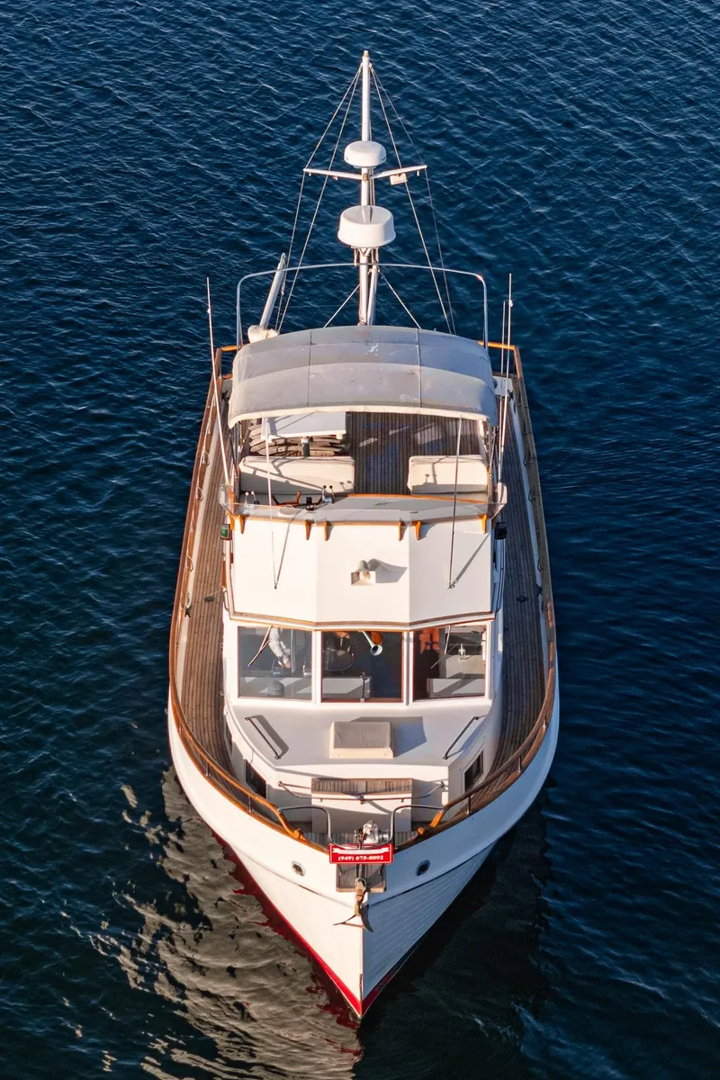 Slide: The Image of 1984 Grand Banks 42 Classic yacht on calm blue water, aerial view. - 17