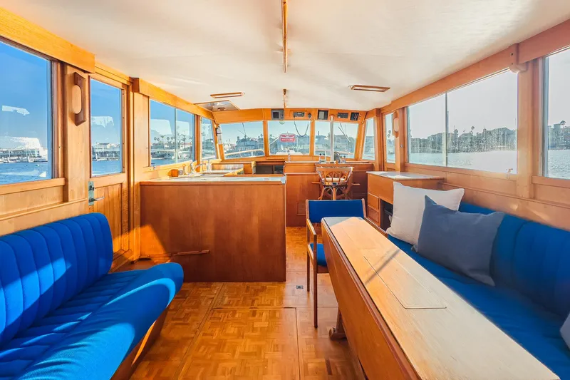 Slide: The Image of Interior of 1984 Grand Banks 42 Classic yacht with blue seating and wooden finishes. - 22