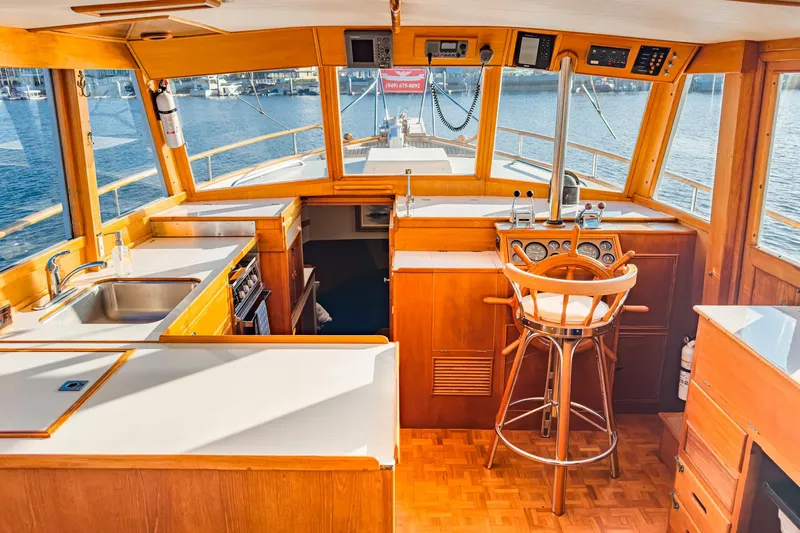 Slide: The Image of Interior of a 1984 Grand Banks 42 Classic yacht with wooden finishes and helm station. - 23