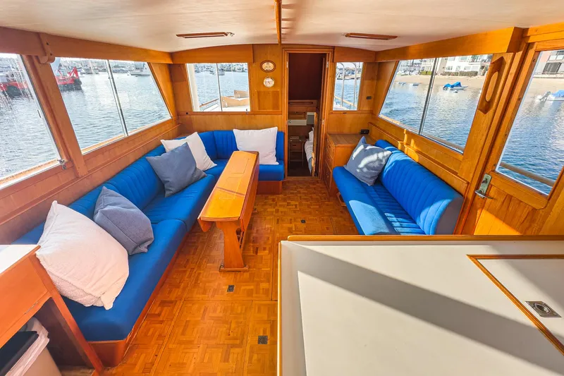 Slide: The Image of Interior of 1984 Grand Banks 42 Classic yacht with blue seating and wooden accents. - 30
