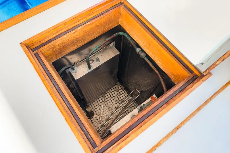 Slide: The Image of Engine compartment of 1984 Grand Banks 42 Classic boat, featuring wooden framing and visible components. - 34