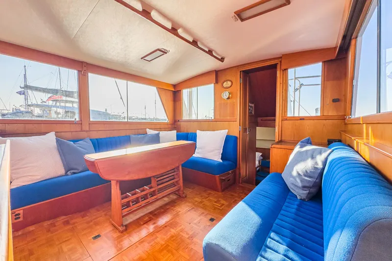 Slide: The Image of Interior of 1984 Grand Banks 42 Classic yacht with blue seating and wooden accents. - 37