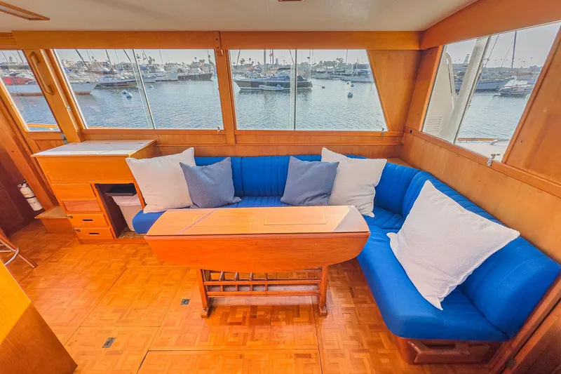 Slide: The Image of Interior of 1984 Grand Banks 42 Classic yacht with blue seating and wooden table. - 38
