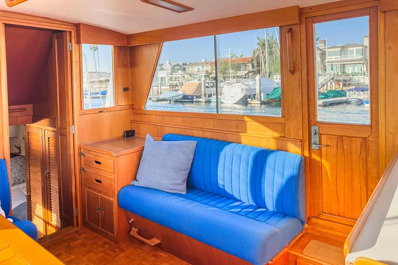 Slide: The Image of Interior of 1984 Grand Banks 42 Classic yacht with blue seating and wooden finish. - 40
