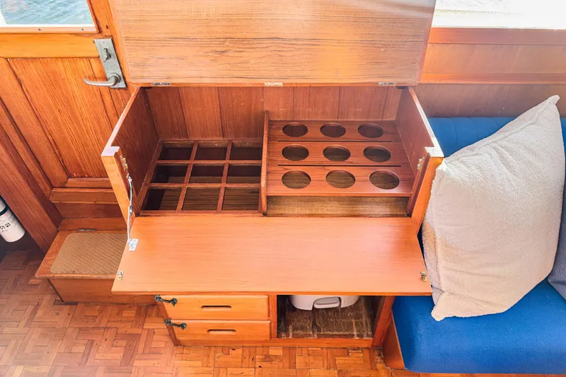 Slide: The Image of 1984 Grand Banks 42 Classic interior with wooden storage compartments and seating area. - 41