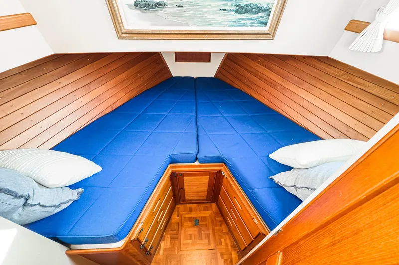 Slide: The Image of V-berth cabin with blue cushions in 1984 Grand Banks 42 Classic yacht. - 43