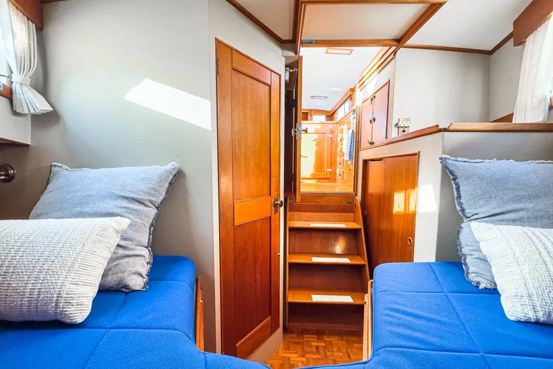 Slide: The Image of Interior of 1984 Grand Banks 42 Classic yacht with twin beds and wooden cabinetry. - 44