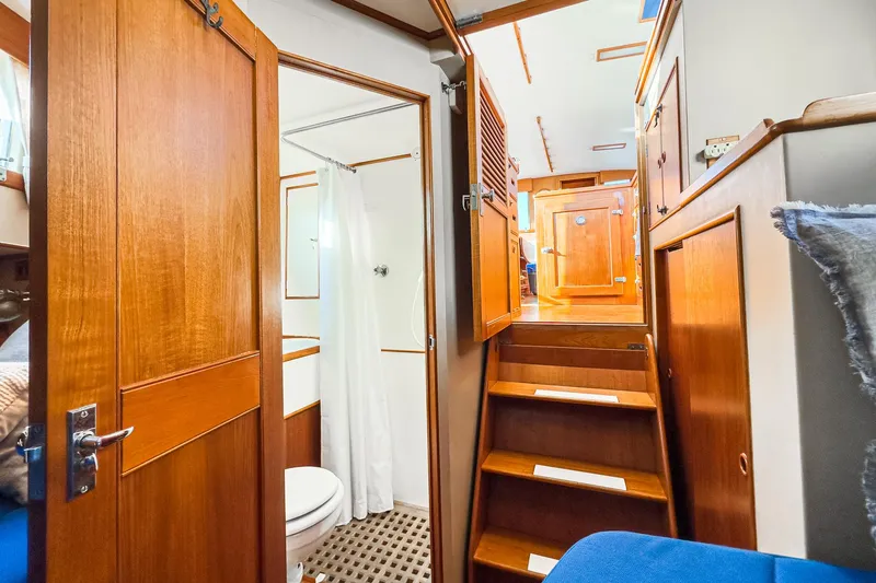 Slide: The Image of Interior of 1984 Grand Banks 42 Classic yacht, featuring wooden stairs and bathroom. - 45