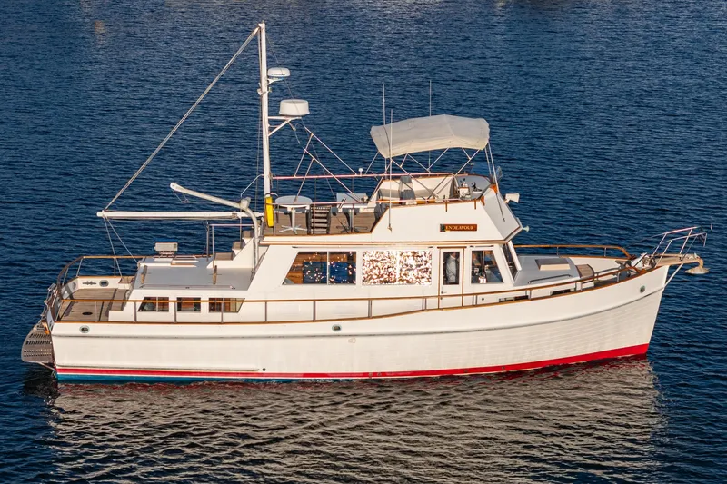 Slide: The Image of 1984 Grand Banks 42 Classic yacht on calm water, showcasing elegant design and craftsmanship. - 5