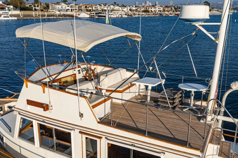 Slide: The Image of 1984 Grand Banks 42 Classic yacht with canopy, docked in a marina. - 9