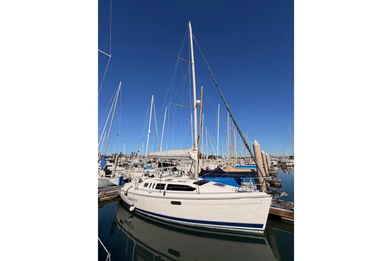Slide: The Image of Sailboat Hunter 336, 1996 model, docked in a marina under clear blue skies. - 1