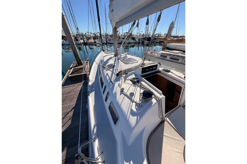 Slide: The Image of Sailboat Hunter 336, 1996 model, docked at marina with clear blue sky. - 15
