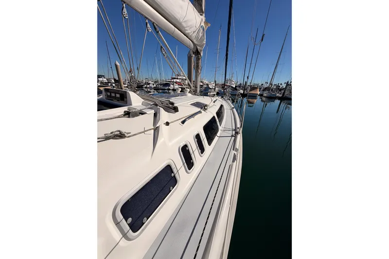 Slide: The Image of Sailboat Hunter 336, 1996 model, docked in a marina under clear blue skies. - 16