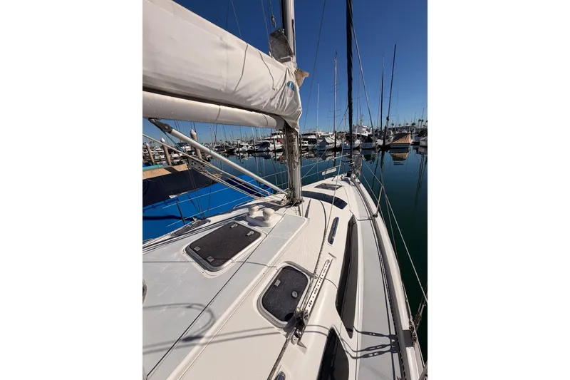 Slide: The Image of Sailboat Hunter 336, 1996 model, docked in a marina under clear blue skies. - 17