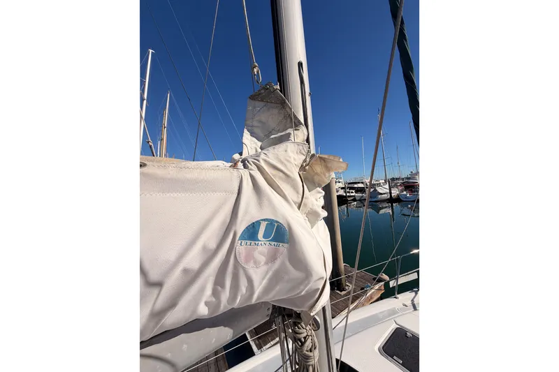Slide: The Image of Sailboat mast and sail with Ullman Sails logo, Hunter 336, 1996 model, docked in marina. - 18