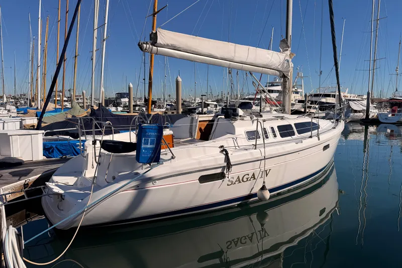 Slide: The Image of Sailboat Hunter 336, 1996 model, docked in a marina with clear blue skies. - 2